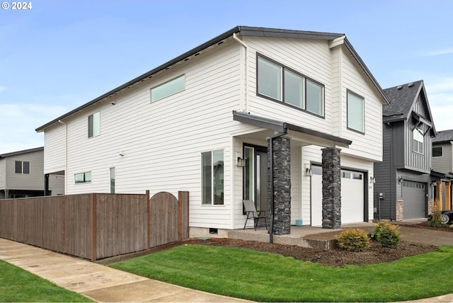 view of front facade with a front yard and a garage