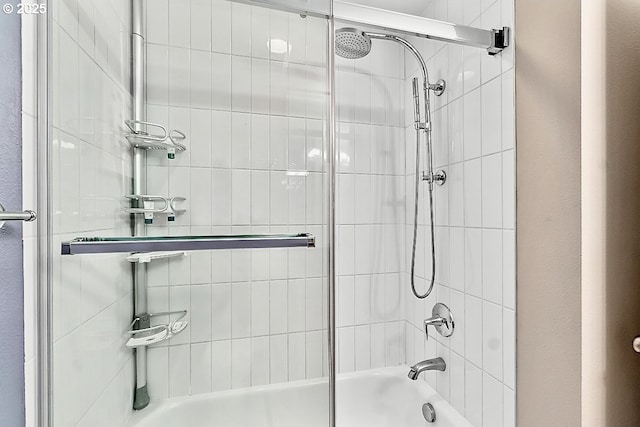 bathroom featuring shower / bath combination with glass door