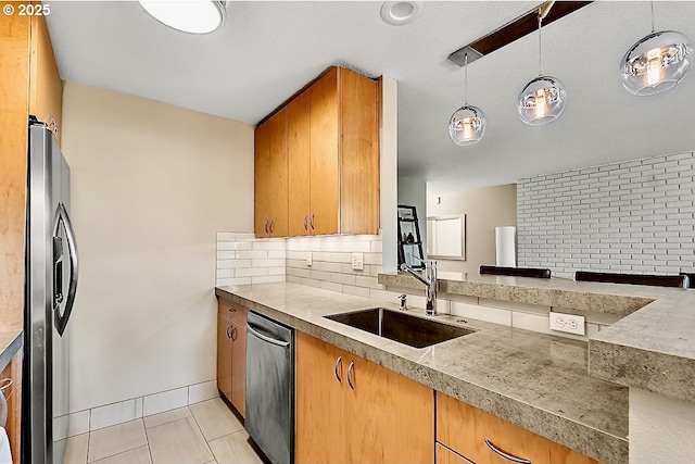 kitchen featuring pendant lighting, dishwasher, sink, decorative backsplash, and stainless steel refrigerator with ice dispenser