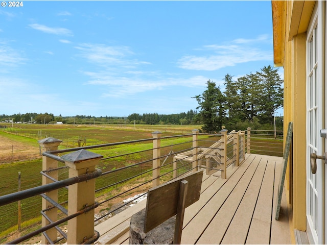 wooden deck with a rural view