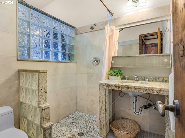 bathroom with walk in shower, tile walls, toilet, and tile patterned floors