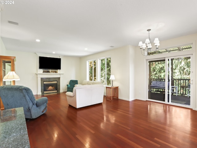 living room featuring a chandelier and dark hardwood / wood-style floors