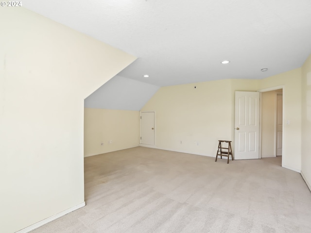 bonus room featuring light carpet and lofted ceiling