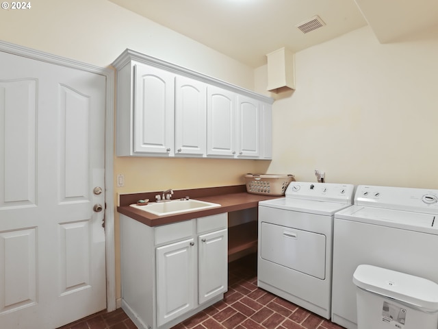 laundry area with cabinets, independent washer and dryer, and sink