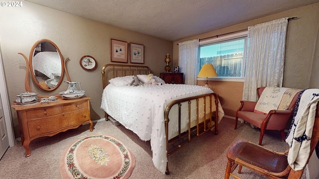 bedroom with a textured ceiling, carpet floors, baseboards, and a textured wall