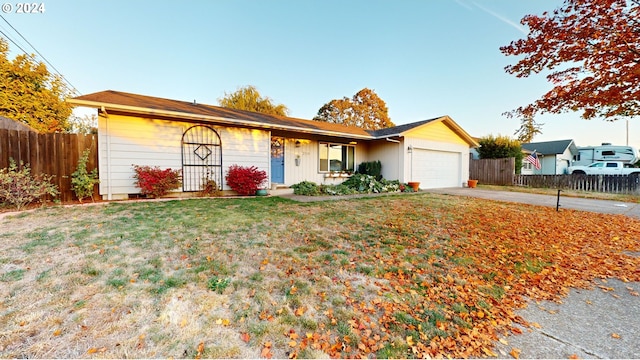 ranch-style home with a front lawn and a garage