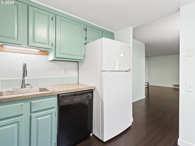 10940 SW Meadowbrook Dr Unit 29, Portland, OR 97224 - kitchen featuring black dishwasher, freestanding refrigerator, a sink, dark wood-style floors, and light countertops
