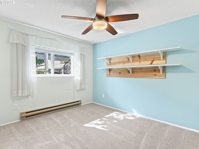 carpeted spare room featuring a textured ceiling and a baseboard heating unit