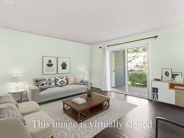 living room with hardwood / wood-style floors and a textured ceiling