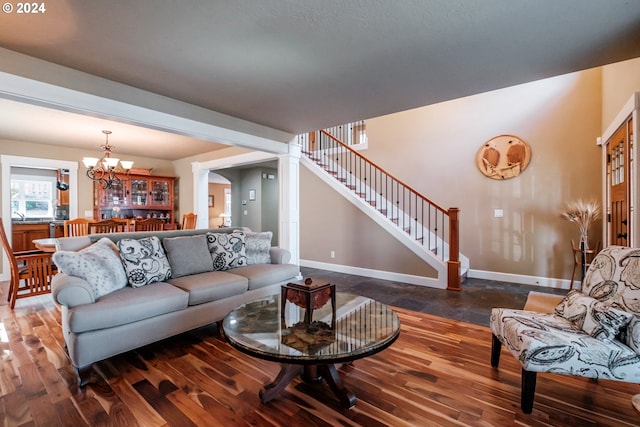 living room with dark hardwood / wood-style flooring and a chandelier