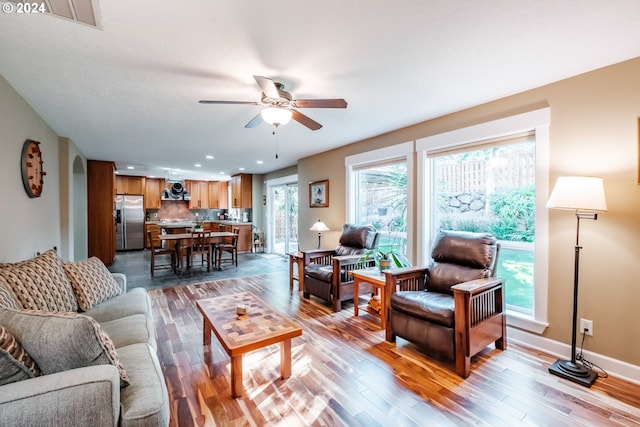 living room with ceiling fan and wood-type flooring