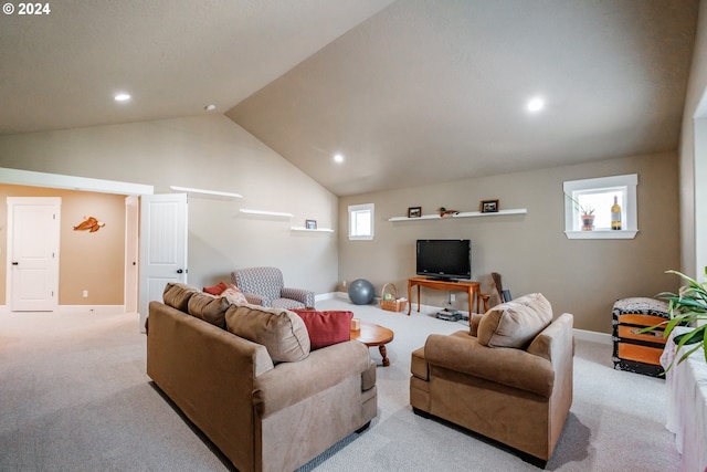 living room featuring light colored carpet, a healthy amount of sunlight, and lofted ceiling