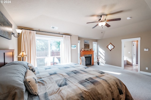 carpeted bedroom featuring ceiling fan and a textured ceiling