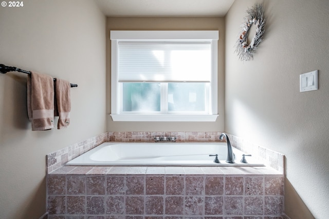 bathroom with a relaxing tiled tub