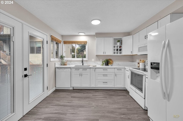 kitchen featuring white cabinetry, white appliances, sink, and light hardwood / wood-style flooring