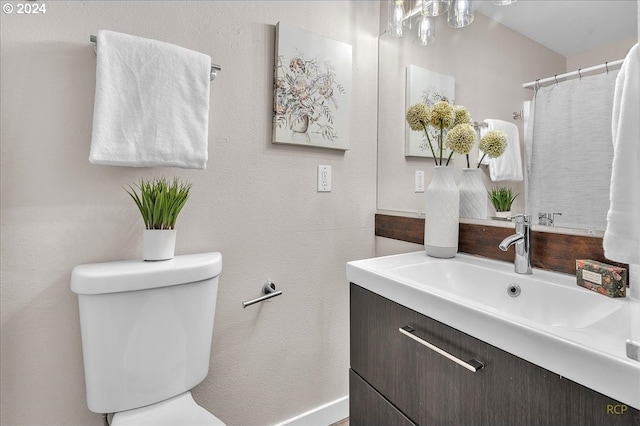 bathroom featuring toilet and vanity