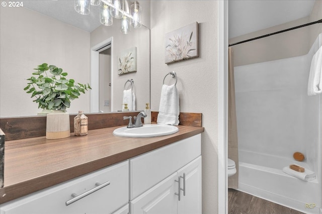 full bathroom featuring wood-type flooring, vanity, toilet, and shower / tub combination