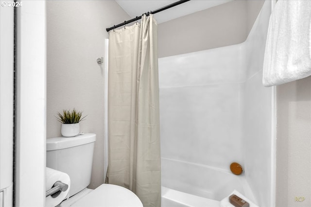 bathroom featuring toilet and shower / bathtub combination with curtain