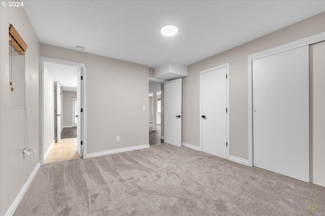 unfurnished bedroom featuring light colored carpet