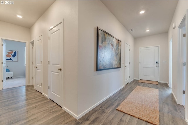 corridor with hardwood / wood-style flooring