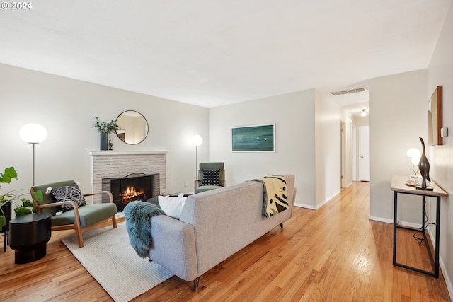 living room featuring a fireplace and light hardwood / wood-style floors