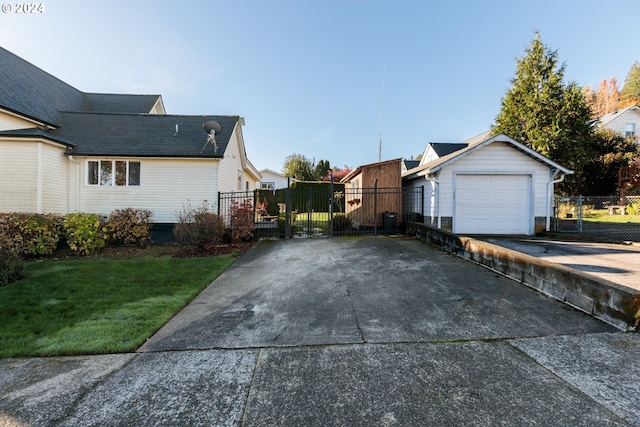 view of home's exterior featuring a garage, a yard, and an outdoor structure