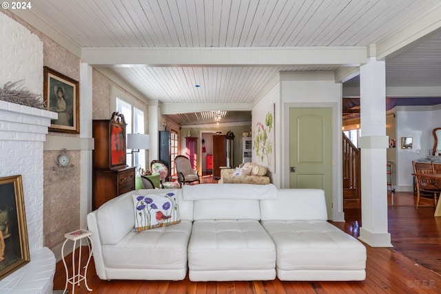 living room with beamed ceiling, wood ceiling, hardwood / wood-style flooring, and a fireplace