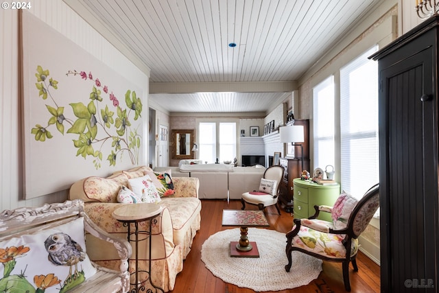 living room featuring beamed ceiling, wood-type flooring, and wooden ceiling