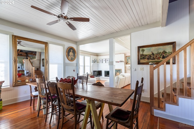 dining room with a wealth of natural light, wood ceiling, and dark hardwood / wood-style flooring