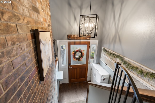 foyer with dark hardwood / wood-style floors and an inviting chandelier