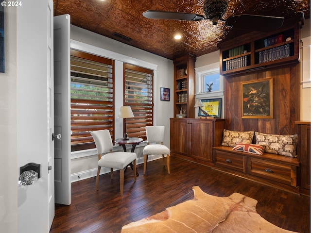 sitting room featuring dark wood-type flooring and ceiling fan