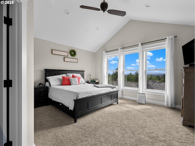 carpeted bedroom featuring ceiling fan and vaulted ceiling