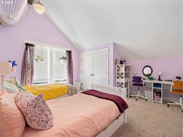 bedroom featuring a closet, carpet, and vaulted ceiling