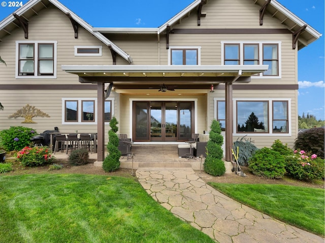 back of property with ceiling fan, a patio, and a yard