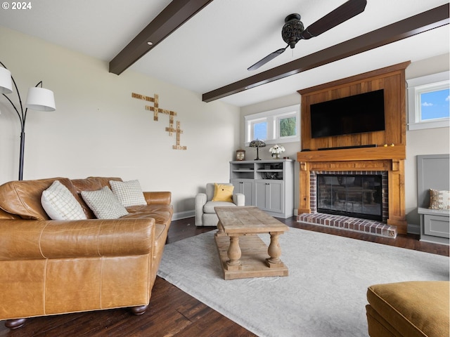 living room with a fireplace, a wealth of natural light, dark hardwood / wood-style floors, and beamed ceiling