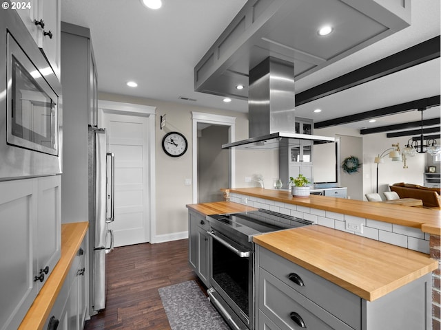 kitchen featuring dark wood-type flooring, gray cabinetry, stainless steel appliances, and wood counters