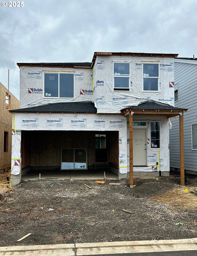 view of front of home with a yard and a garage