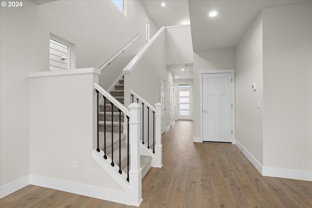 13886 SW Sabrina Ave, Tigard, OR 97140 - entrance foyer featuring baseboards, wood finished floors, a towering ceiling, and stairs