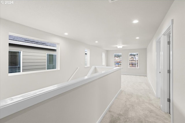 hallway with light colored carpet