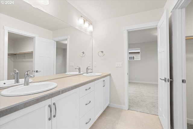 13886 SW Sabrina Ave, Tigard, OR 97140 - bathroom with double vanity, baseboards, and a sink