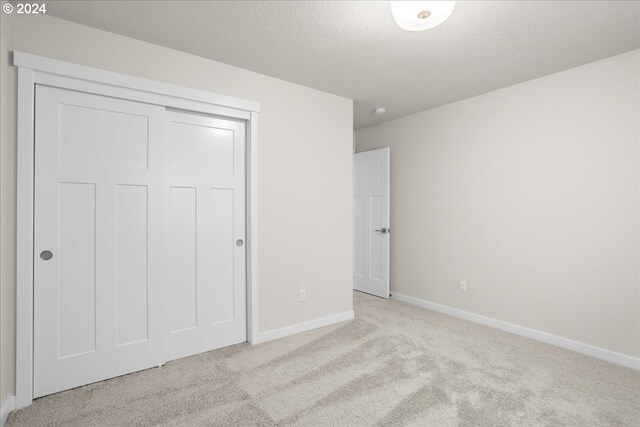 empty room with carpet and a textured ceiling