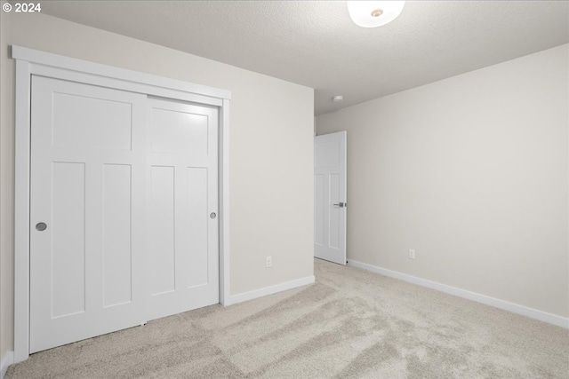 13886 SW Sabrina Ave, Tigard, OR 97140 - unfurnished bedroom with baseboards, a closet, a textured ceiling, and carpet