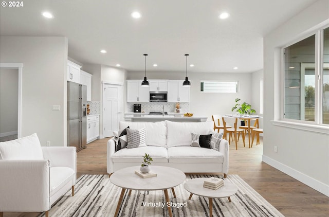 living room with plenty of natural light and light hardwood / wood-style floors