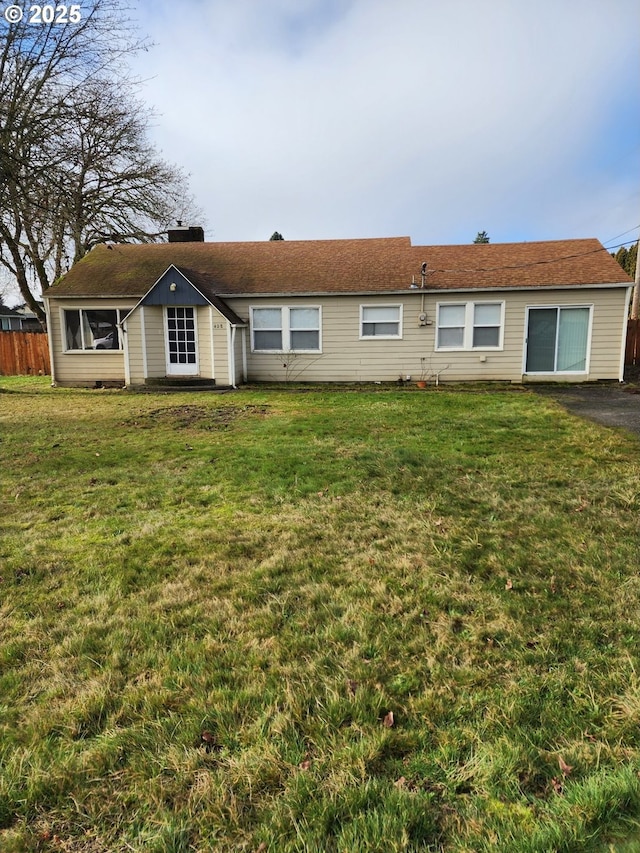 back of house with a yard