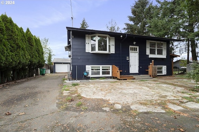 bi-level home with an outbuilding and a garage