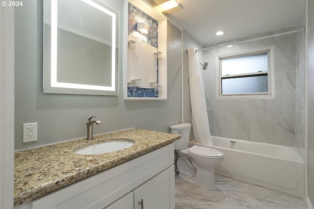 full bathroom with vanity, shower / tub combo with curtain, and toilet