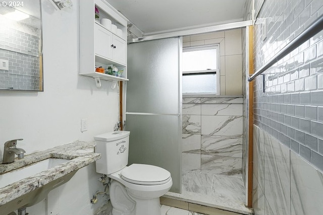 bathroom featuring toilet, tile walls, sink, and tiled shower