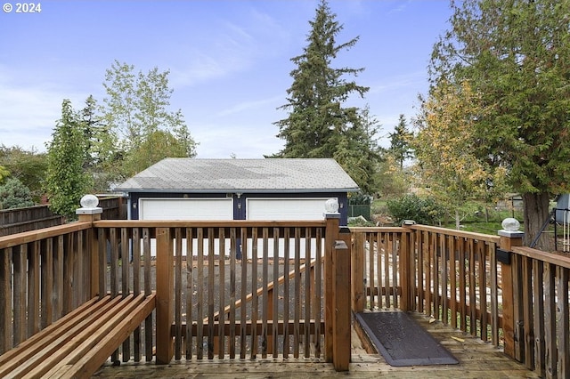 7825 SE Bybee Blvd, Portland, OR 97206 - wooden terrace with a detached garage, an outdoor structure, and a fenced backyard