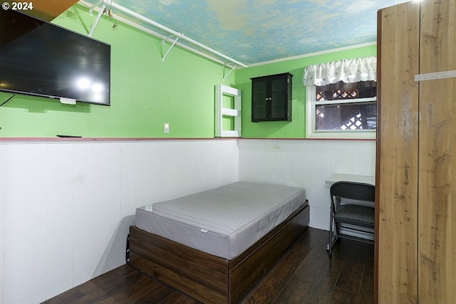 bedroom featuring dark wood-type flooring and crown molding