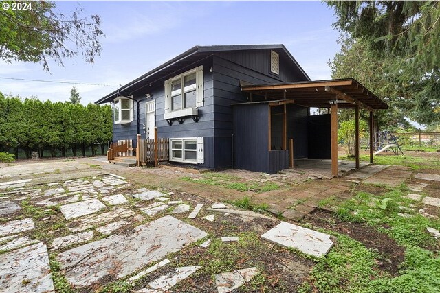 view of side of home with a patio